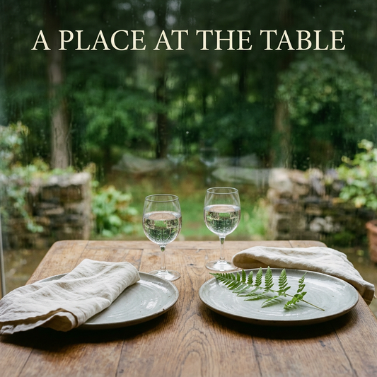 Two stoneware place settings with ivory linen and clear glasses beneath the headline A Place at the Table